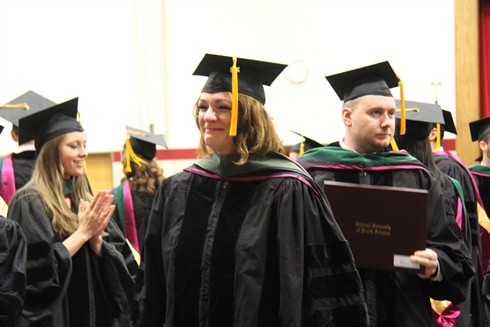 graduates celebrating at april commencement ceremony