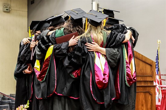NUHS students hugging at commencement