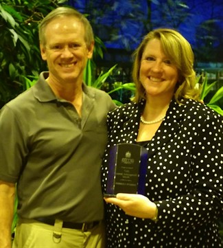 Dr. Jerrilyn Cambron holding Distinguished Service Award