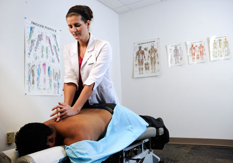 nuhs dc intern white coat adjusting patinet clinic