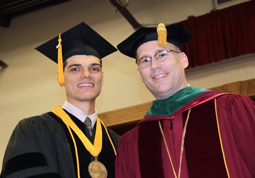 Jack Raymond Webber III, valedictorian of the chiropractic program, with President Stiefel