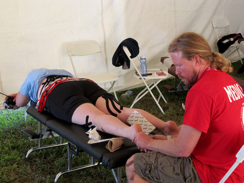 NUHS intern treating patient in medical tent