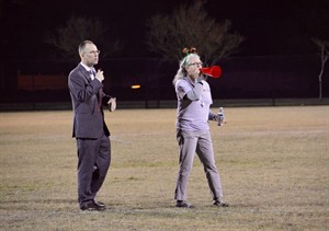 President Joe Stiefel performs turkey bowl coin toss with staff member Deb Bechtel as referee