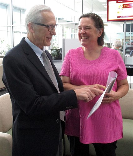 Gregory Cramer being shown journal at author showcase