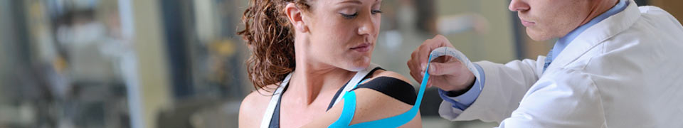 specialist performing kinesiology taping on patient