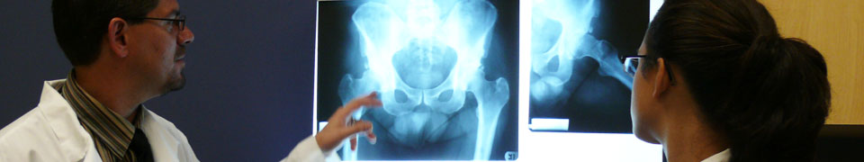 student and faculty looking at xray