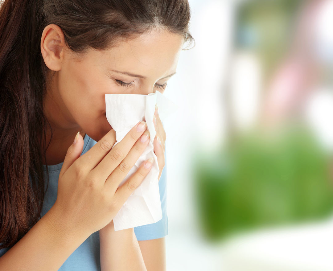 woman blowing her nose
