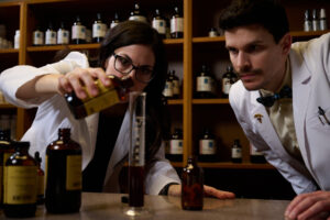 Students measuring naturopathic medicine in dispensary