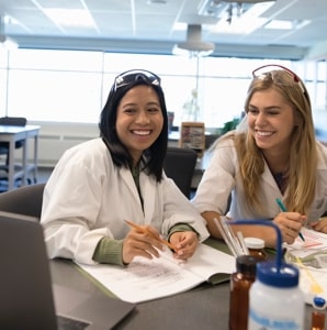 two female students in science class