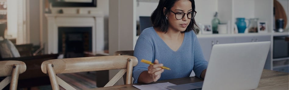student looking at financial aid on laptop