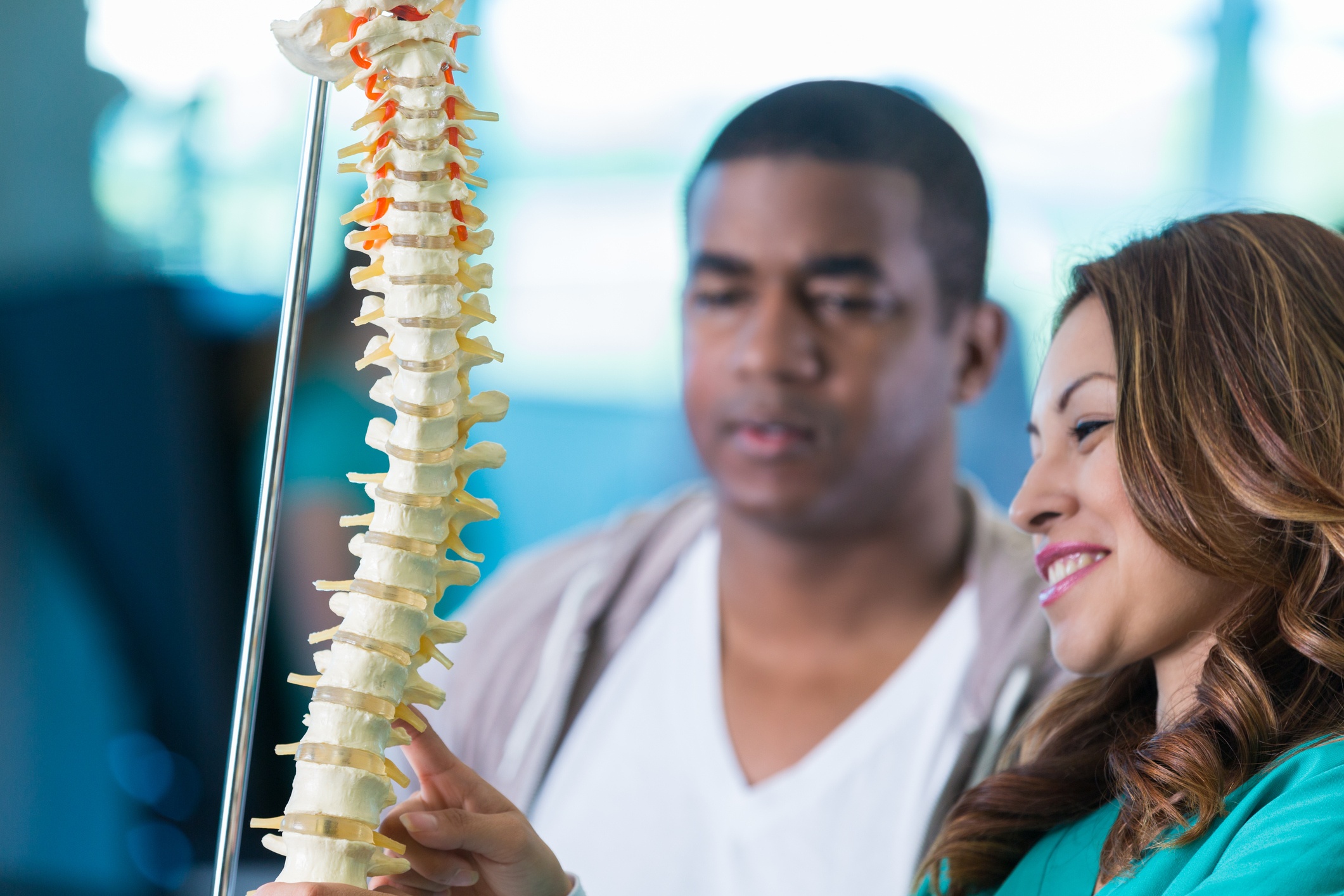 chiropractic students examining a spine model