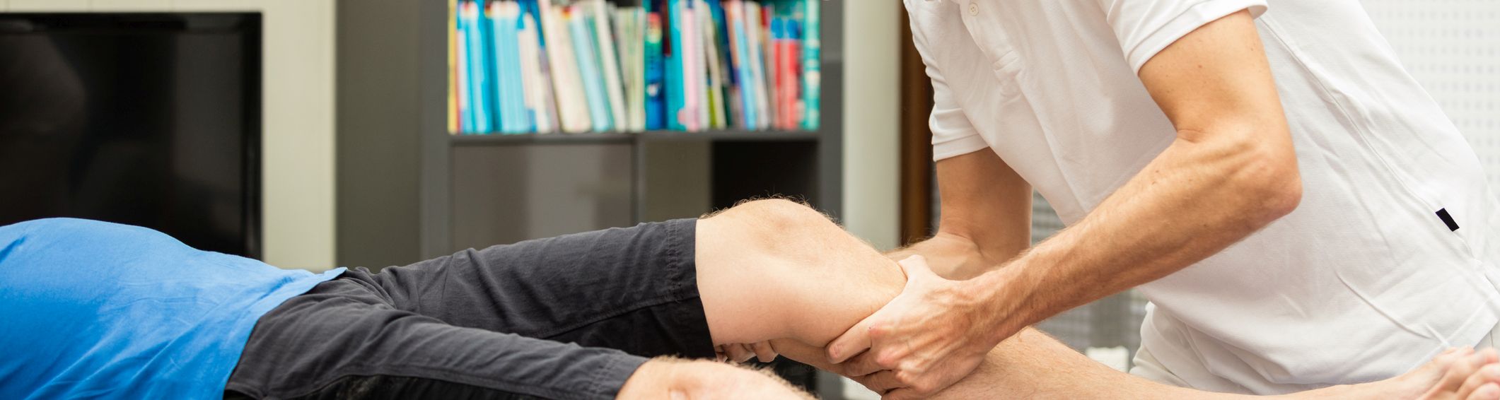 chiropractor testing the knee on athlete