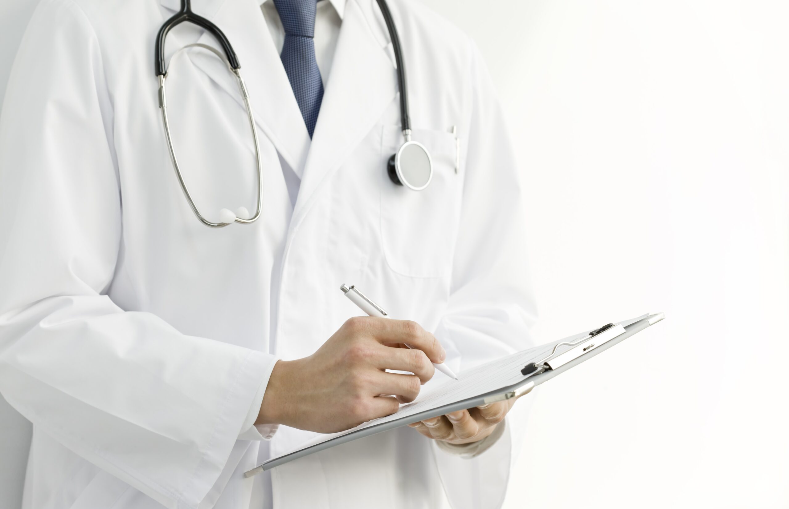 Doctor takes patient notes on clipboard