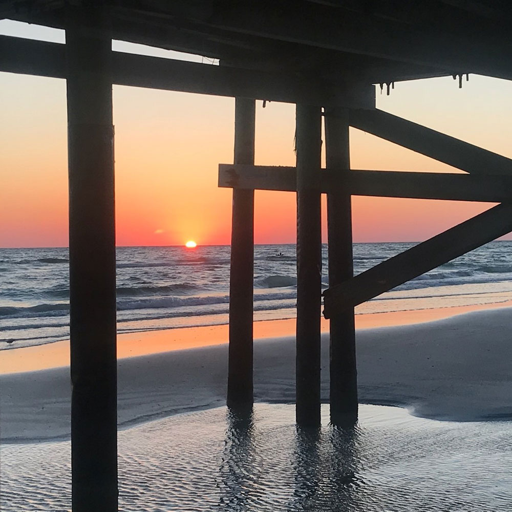 florida sunset over beach and under dock