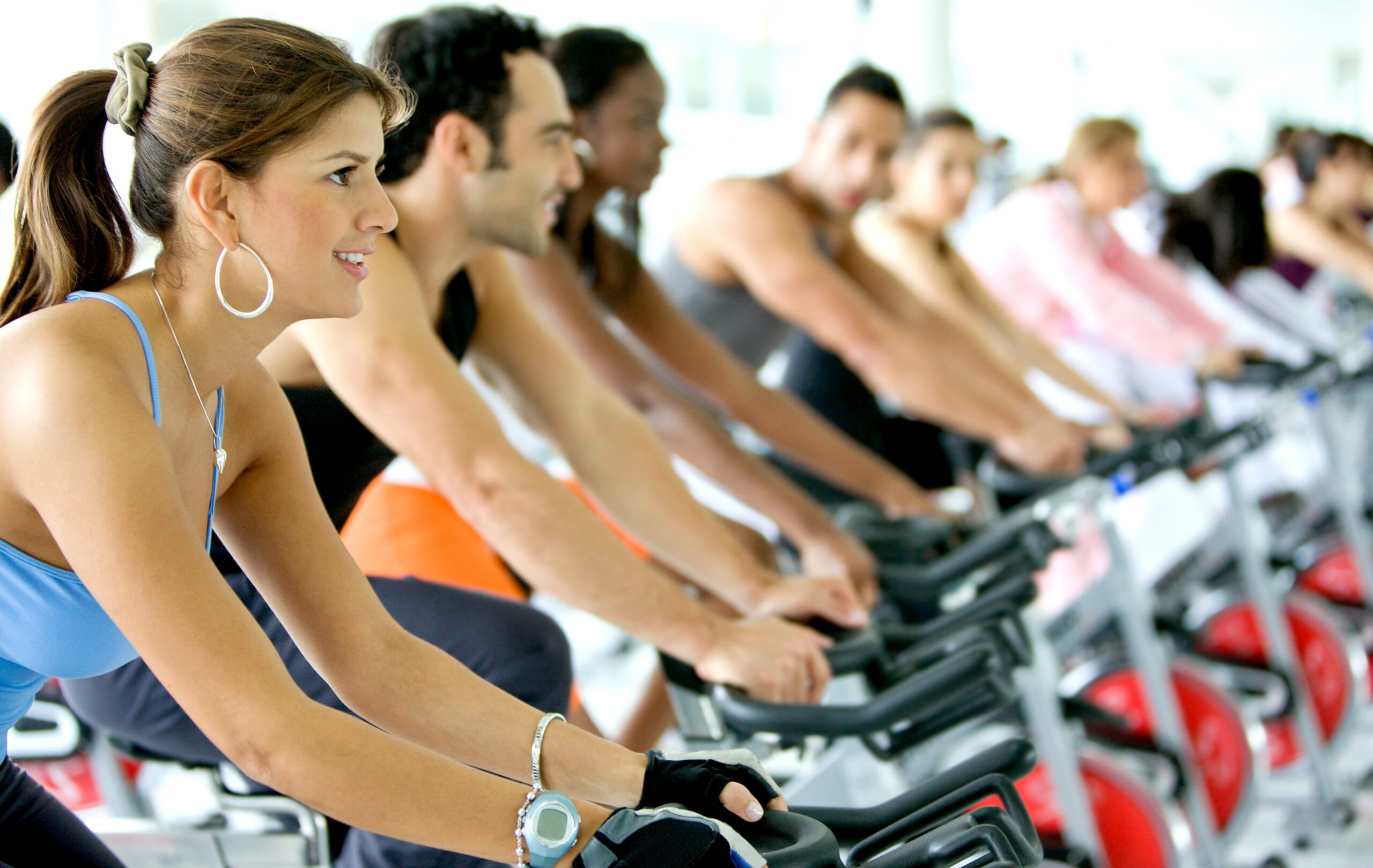 Stationary bike riders in gym.