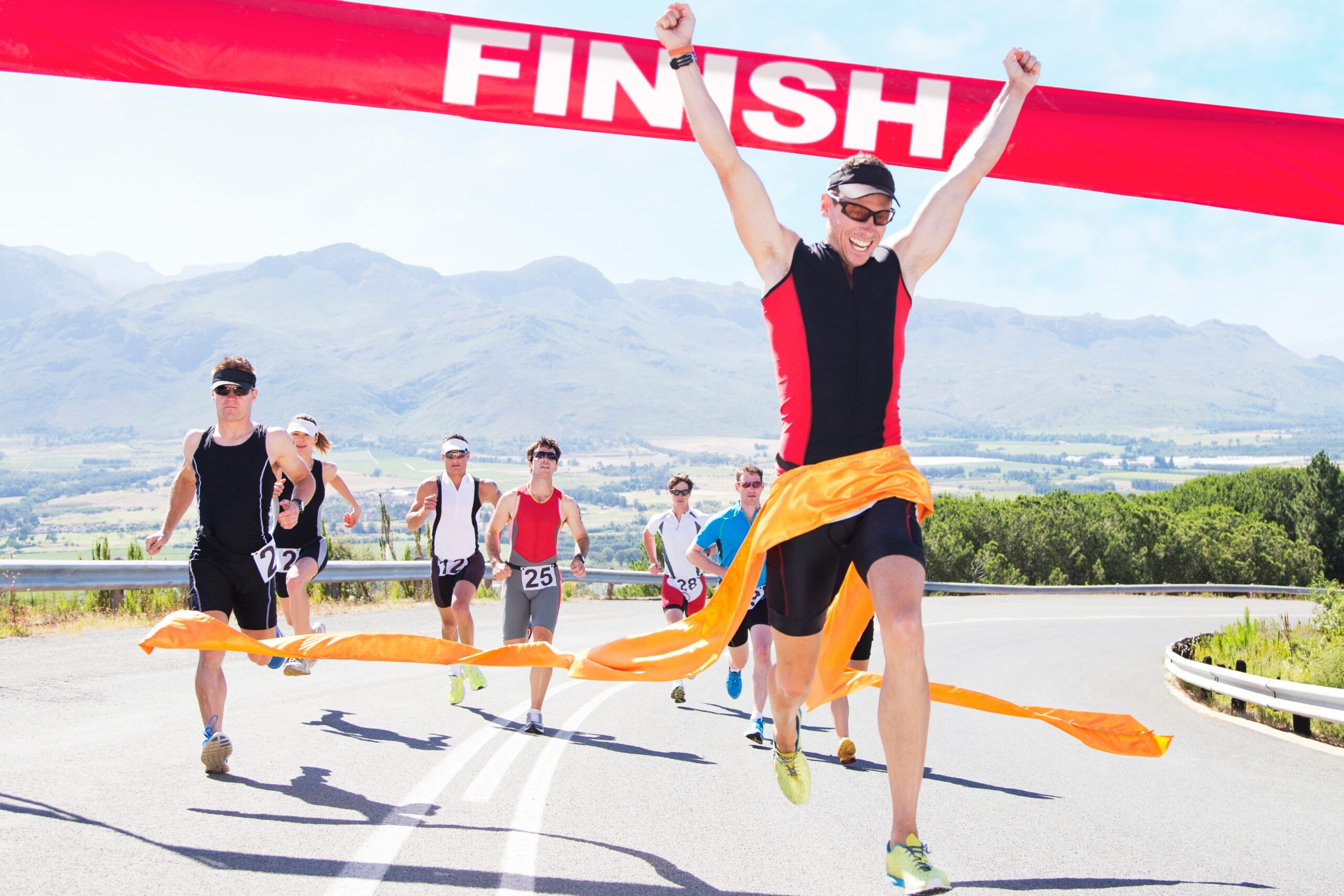 Runners crossing the finish line of track and field race