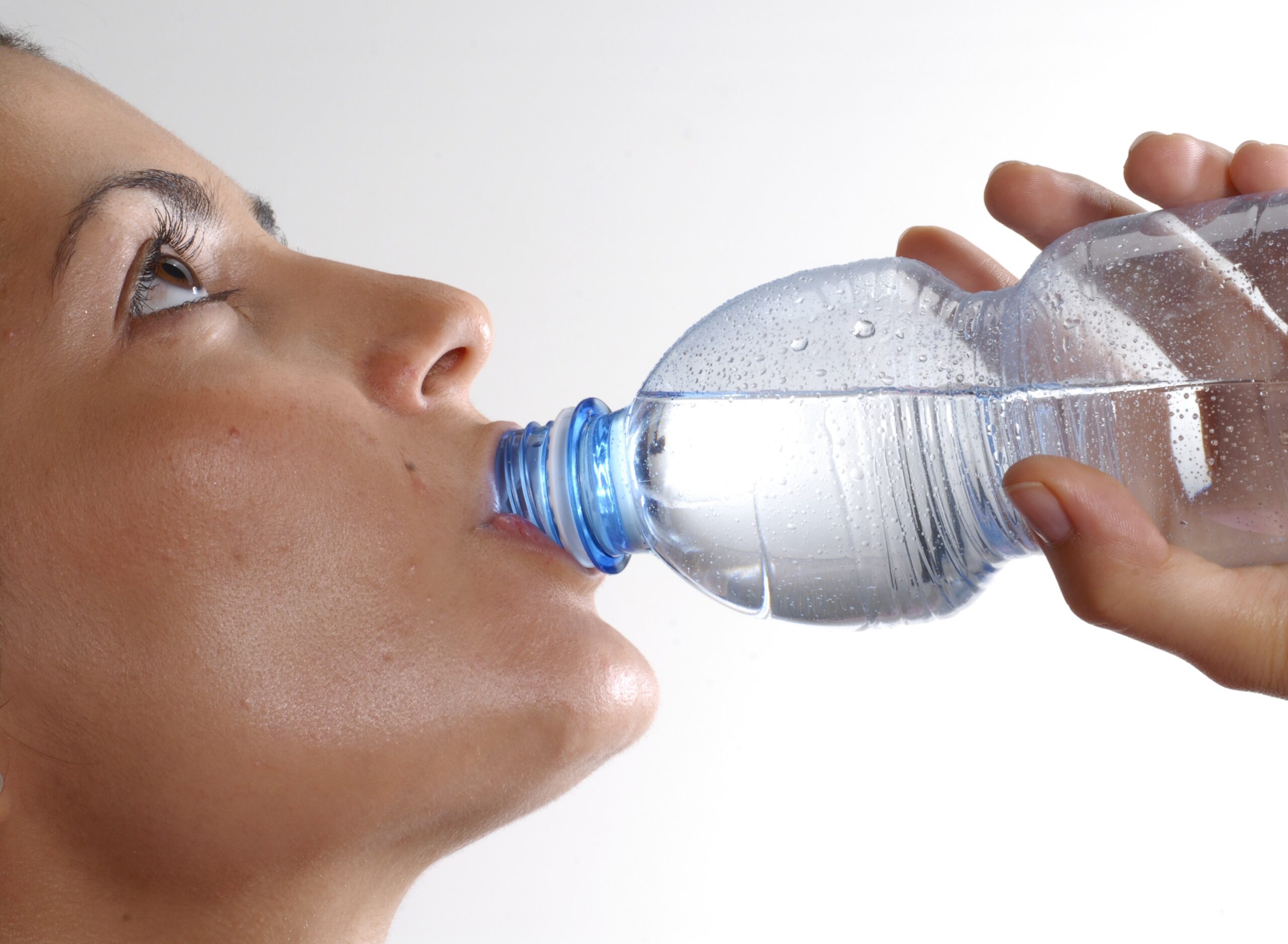 Young woman drinking bottled water