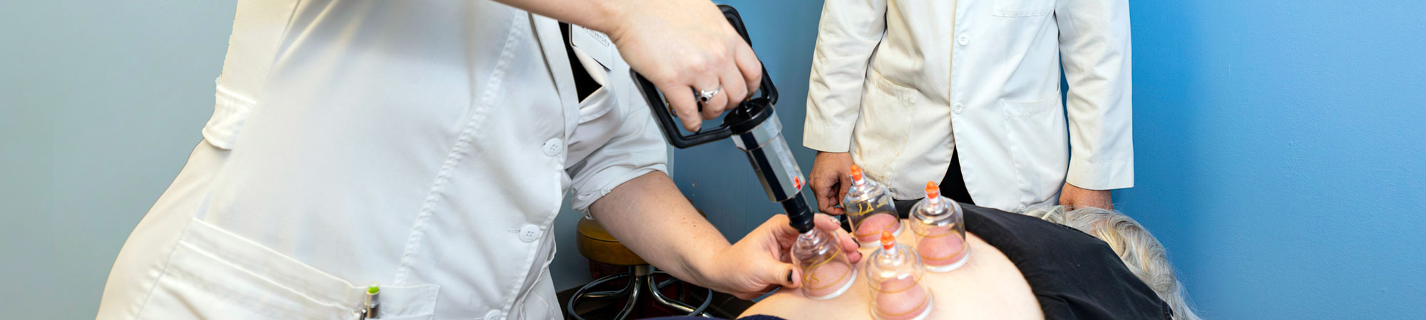 instructor and student doing cupping in clinic