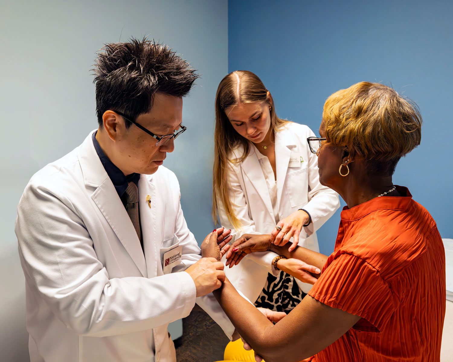 acupuncture staff and students working with clinic patient