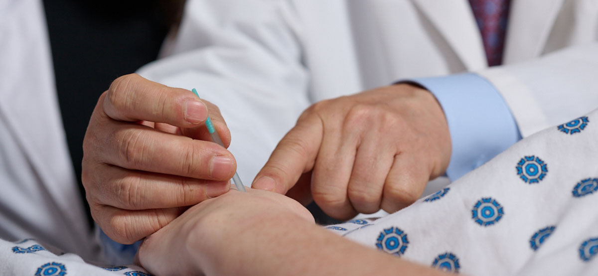 teaching showing student acupuncture procedure