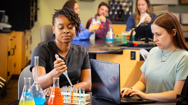 multiple students working in the biochemistry lab
