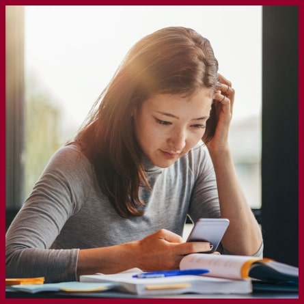 female student looking at her phone