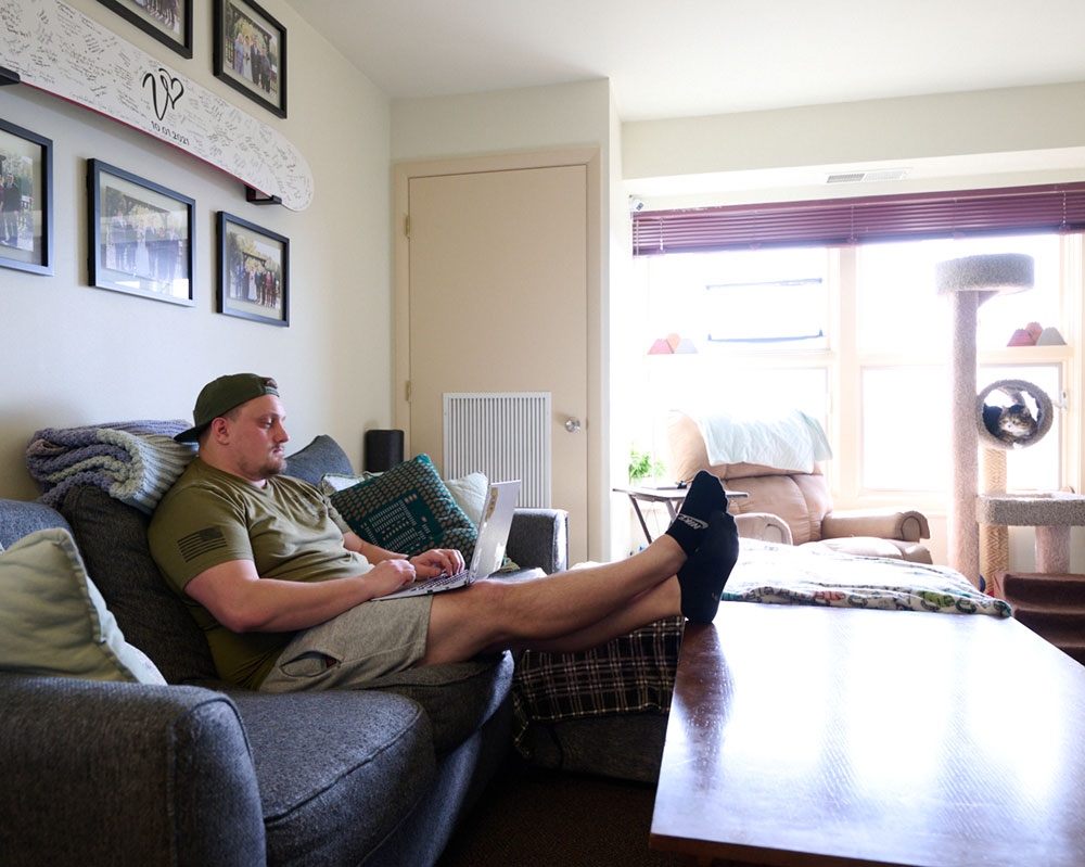 student studying in housing living room