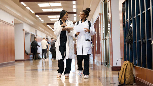 two female students walking down janse hallway