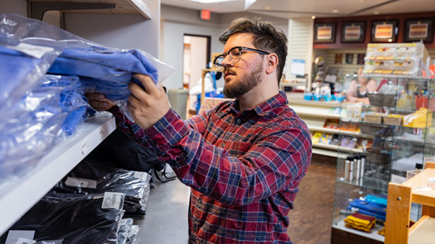 student looking at items in campus store