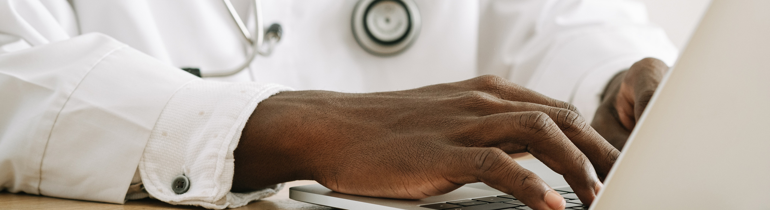 woman typing on laptop keyboard
