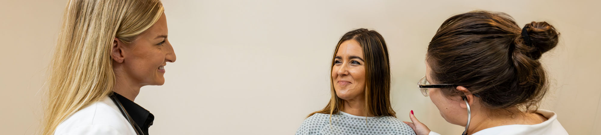 patient being examined by student and health professional