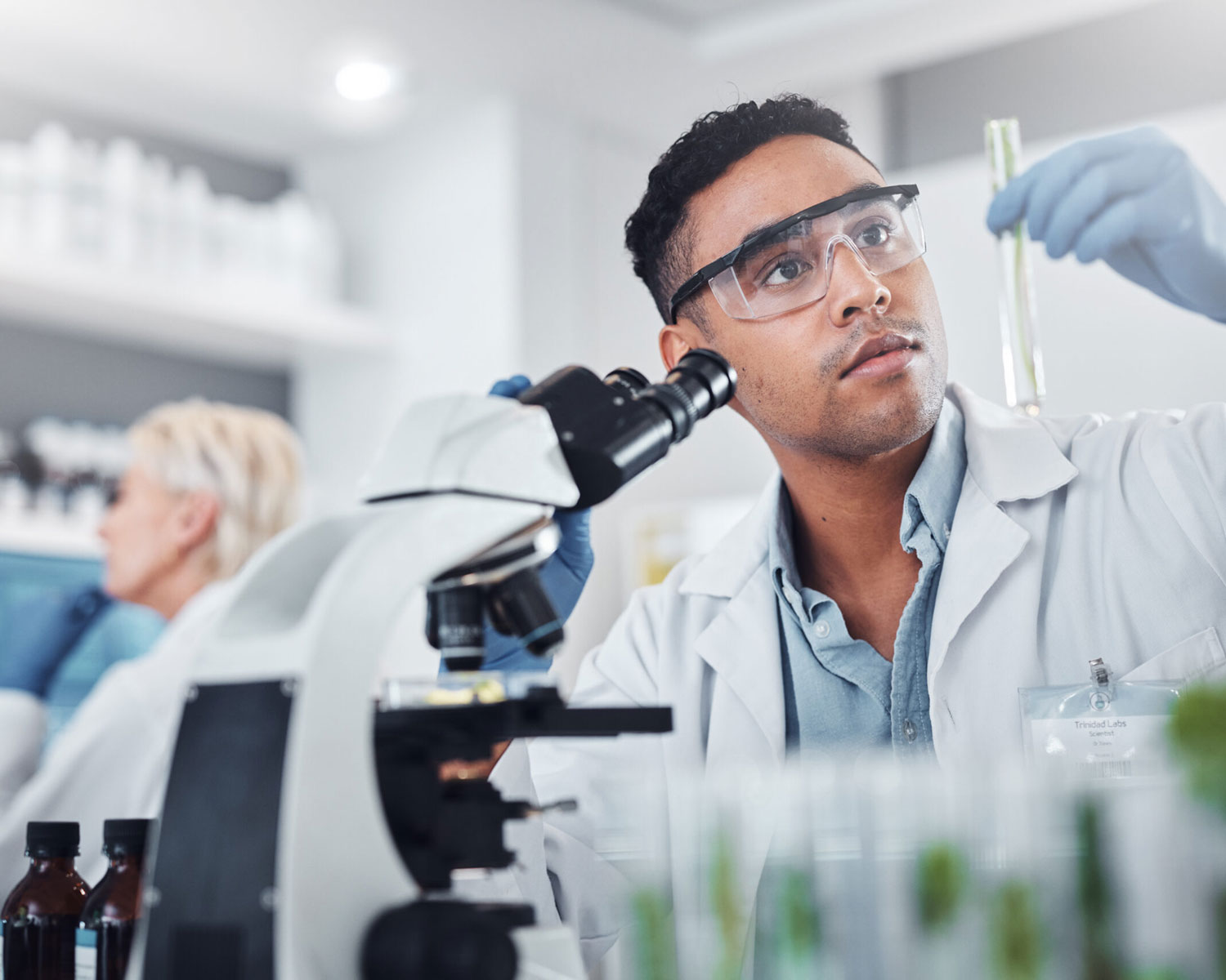Black man, scientist and lab with test tube research
