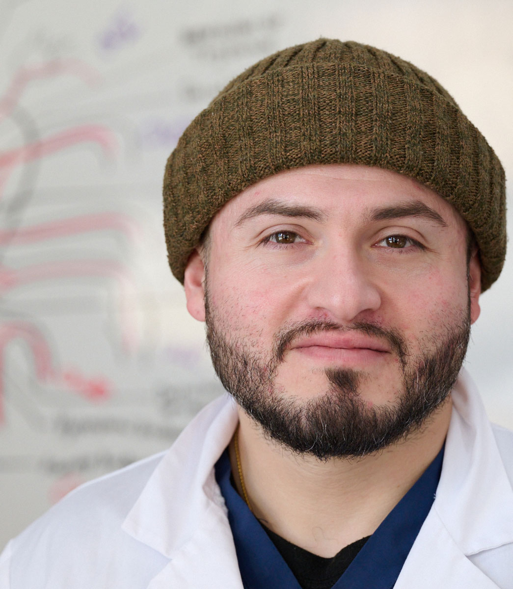 student smiling in front of white board