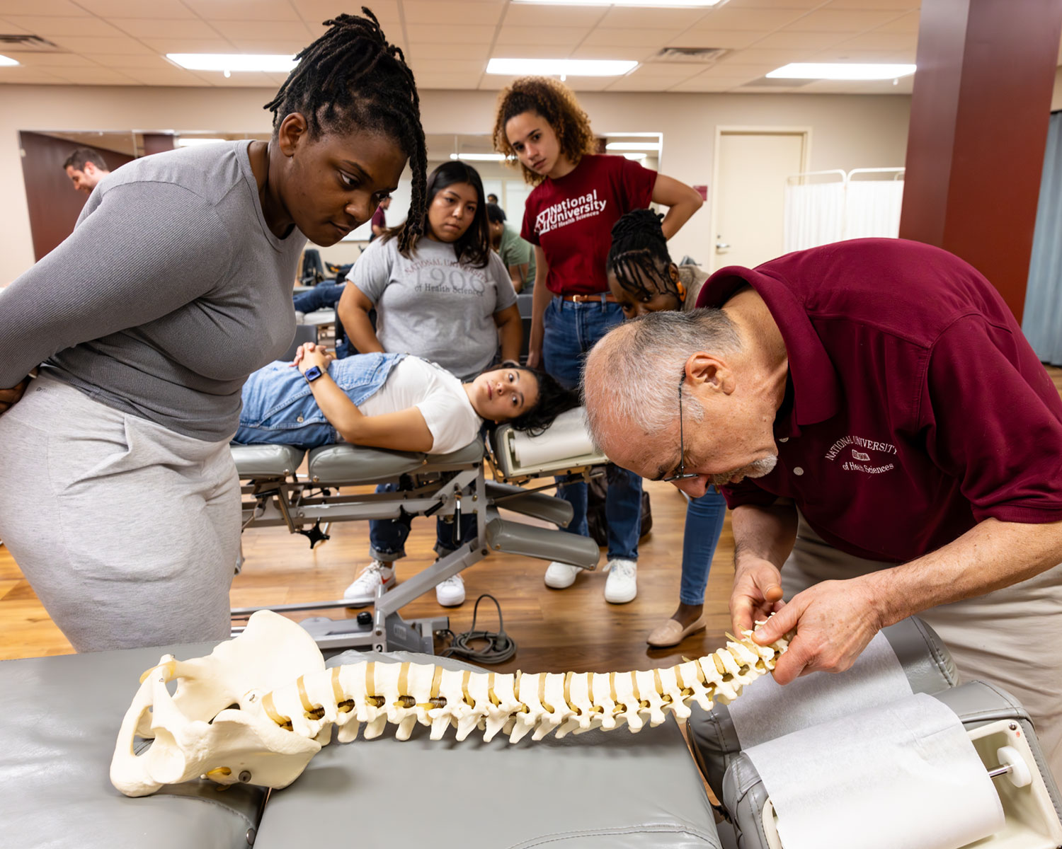 instructor showing class techniques on a model