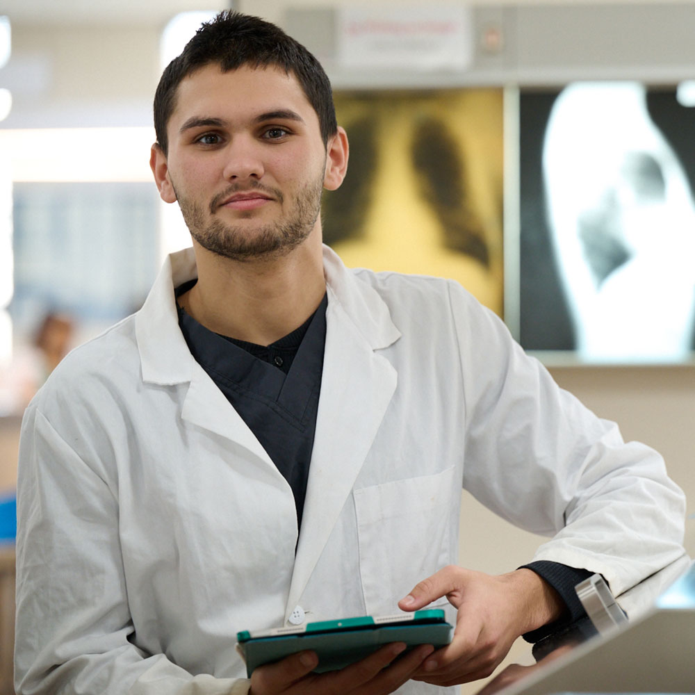 student standing in front of x-rays
