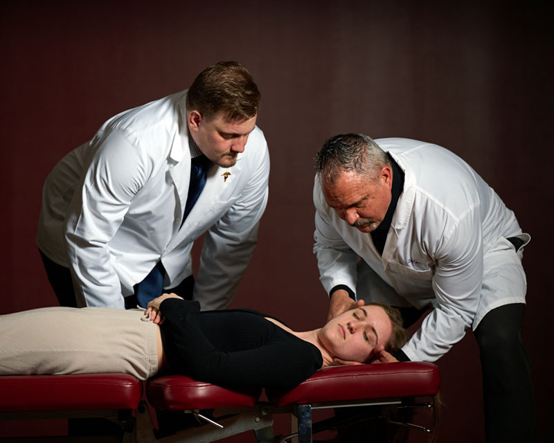 student watching instructor adjust another student