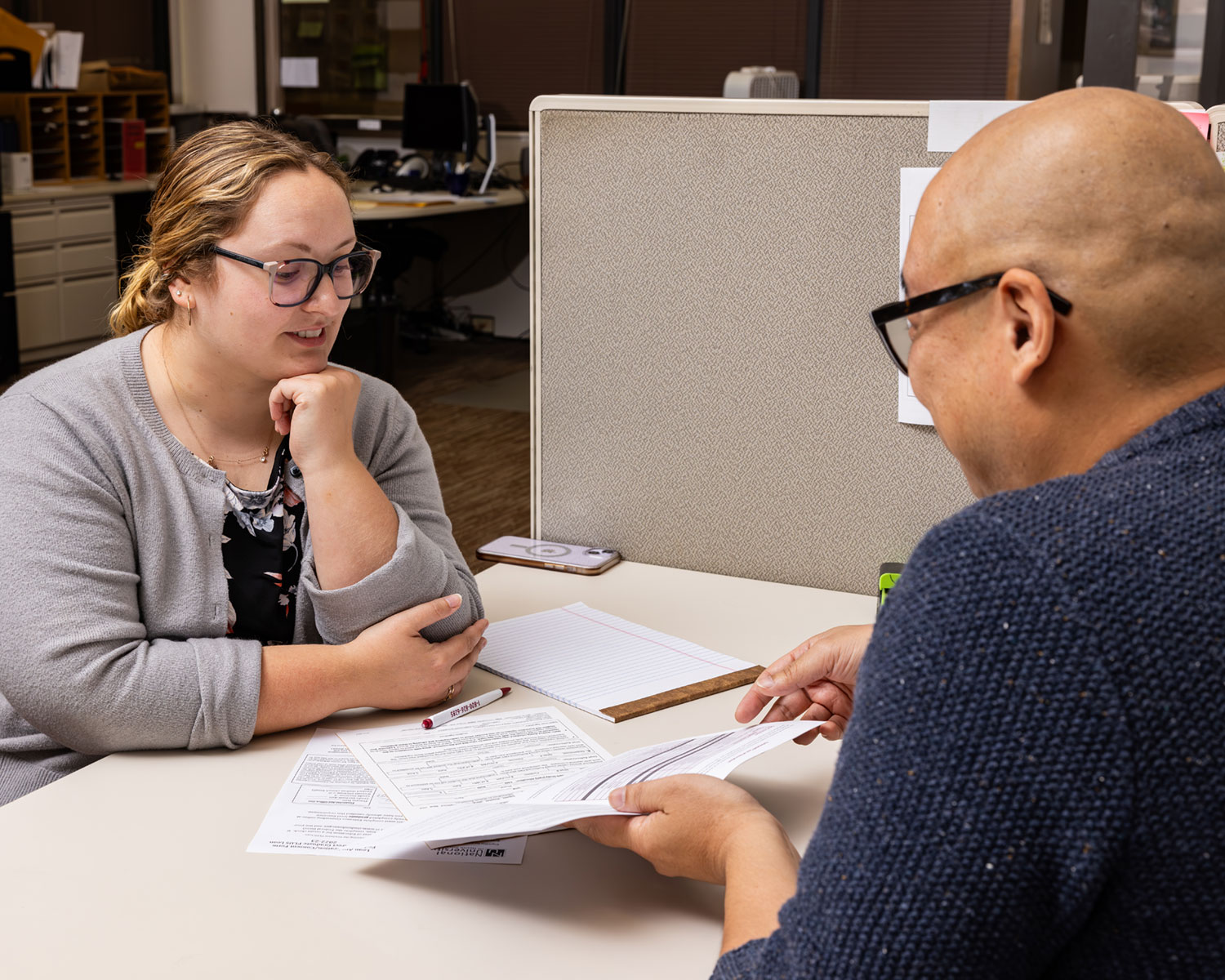 Two NUHS employees reviewing paperwork