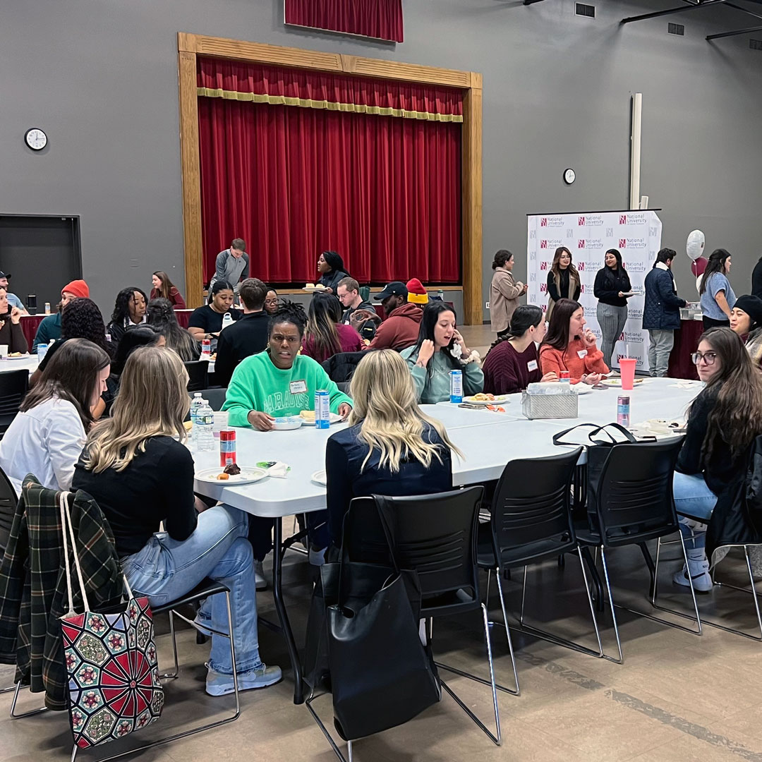 visitors eating lunch with students at NUHS experience