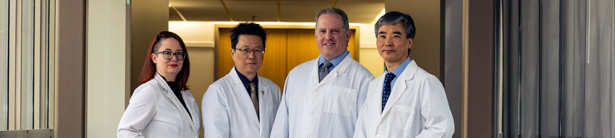 NUHS faculty wearing white lab coats