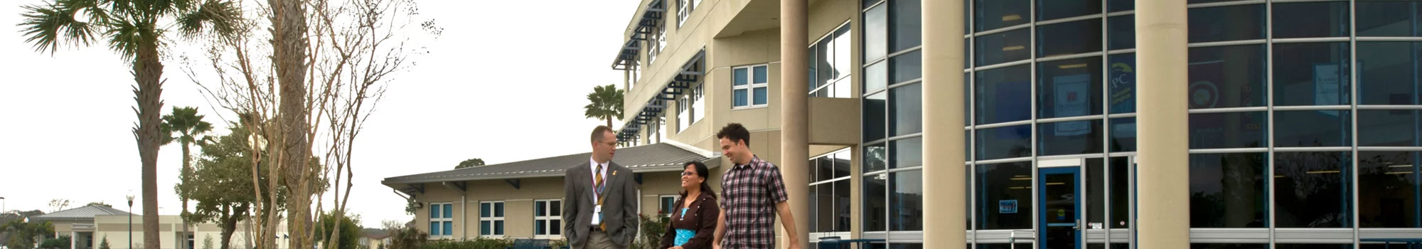 president and students walking outside of florida site
