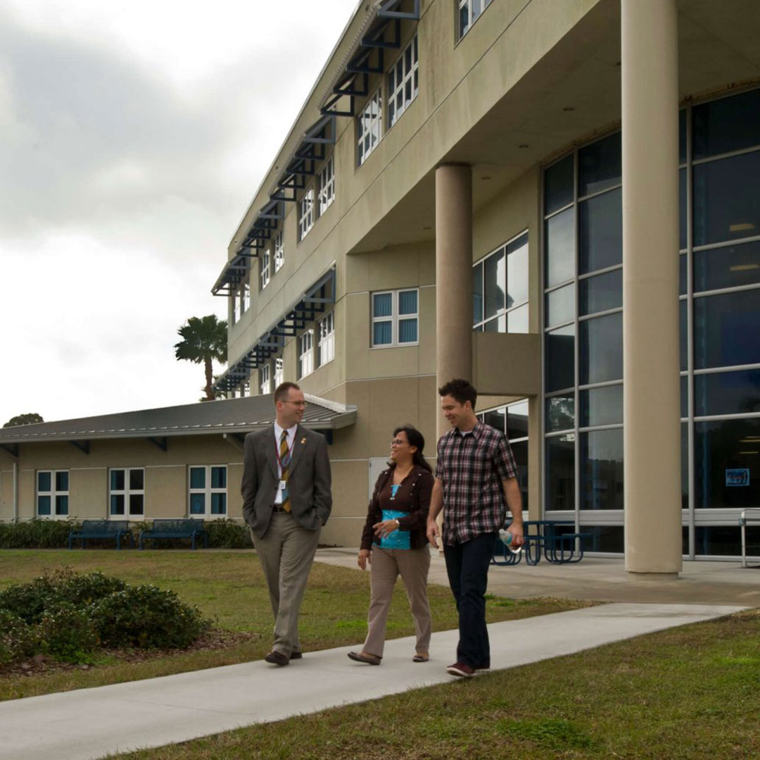 president walking with students outside florida site