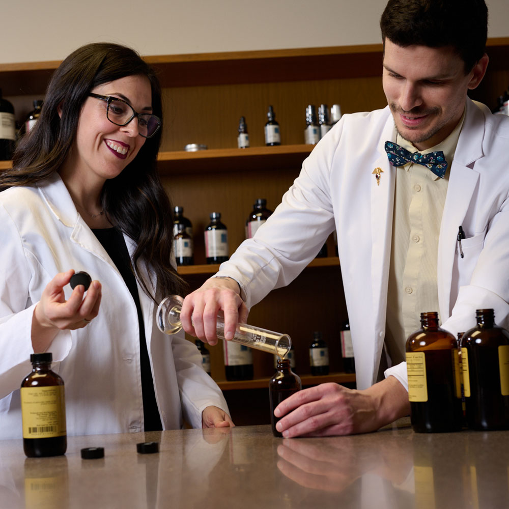 two students mixing herbal medicine