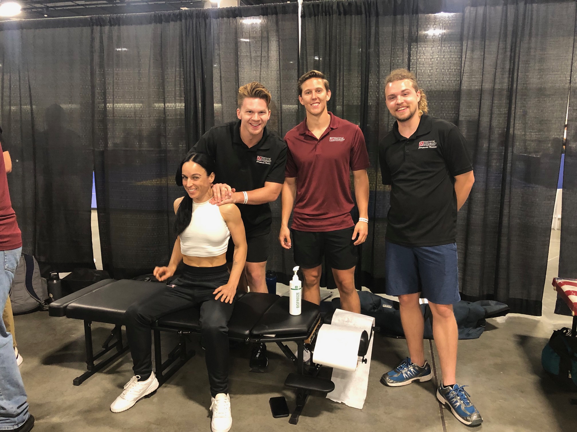 NUHS students adjust a Judo participant