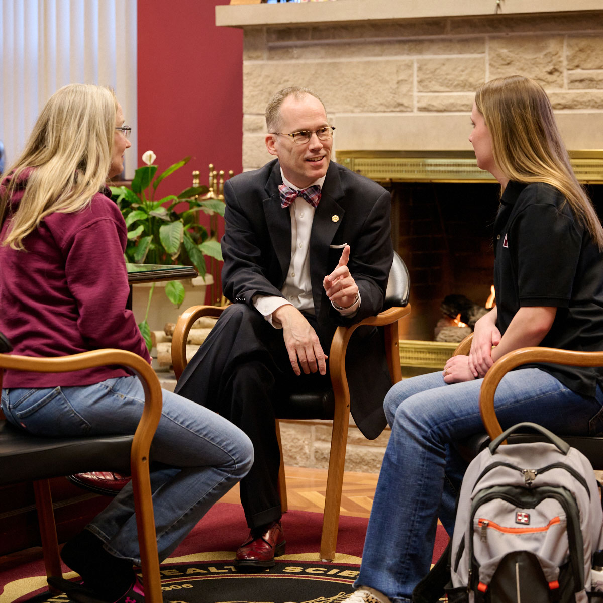 President Stiefel in his office talking to students and faculty