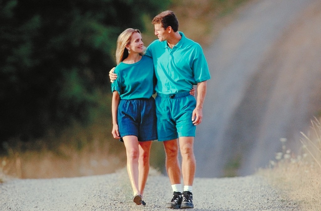 middle aged couple trail walking