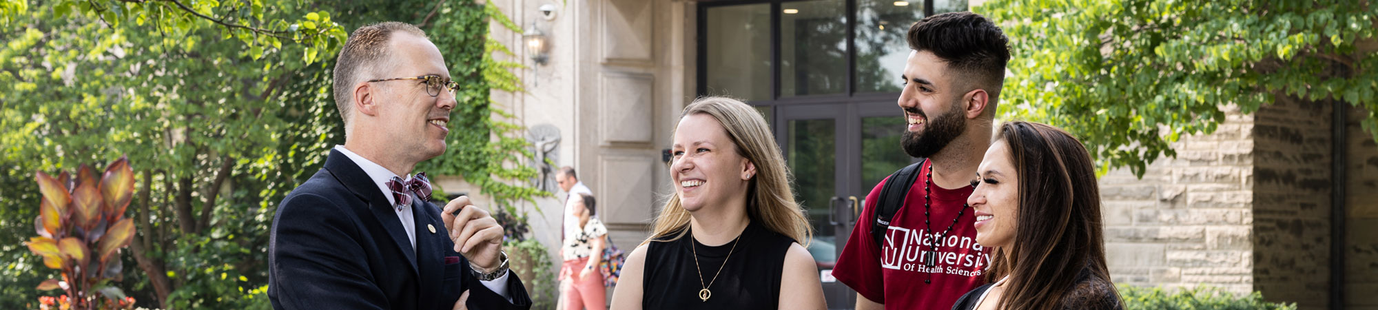 president with students on the campus lawn