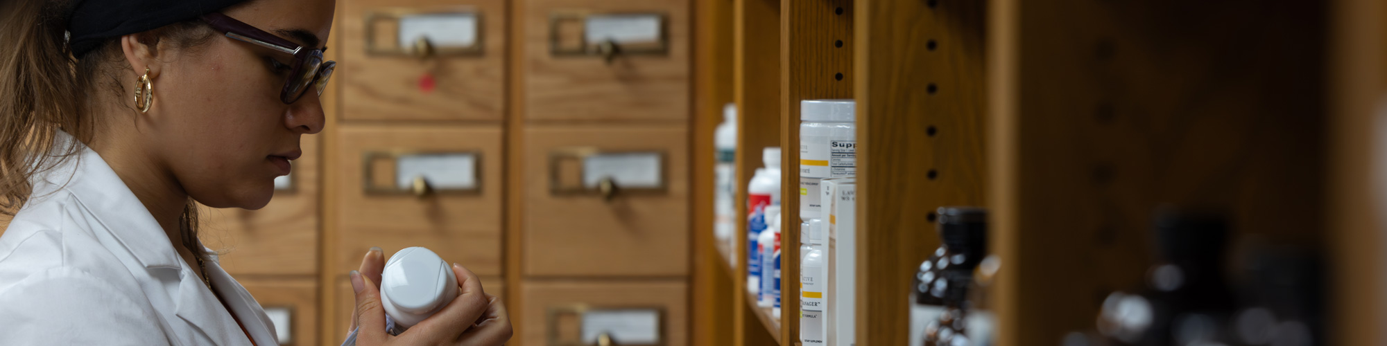 NUHS Naturopathic student working in dispensary