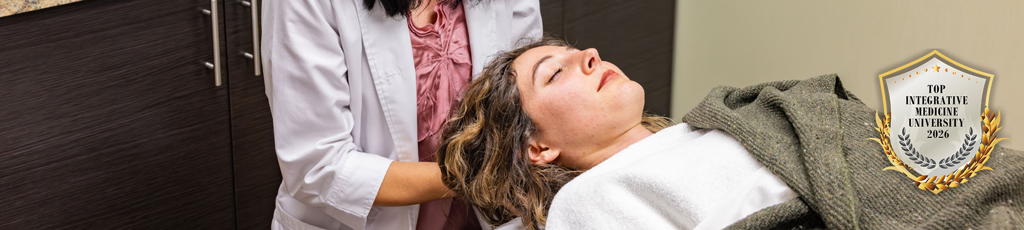 nd intern working with patient in hydrotherapy suite