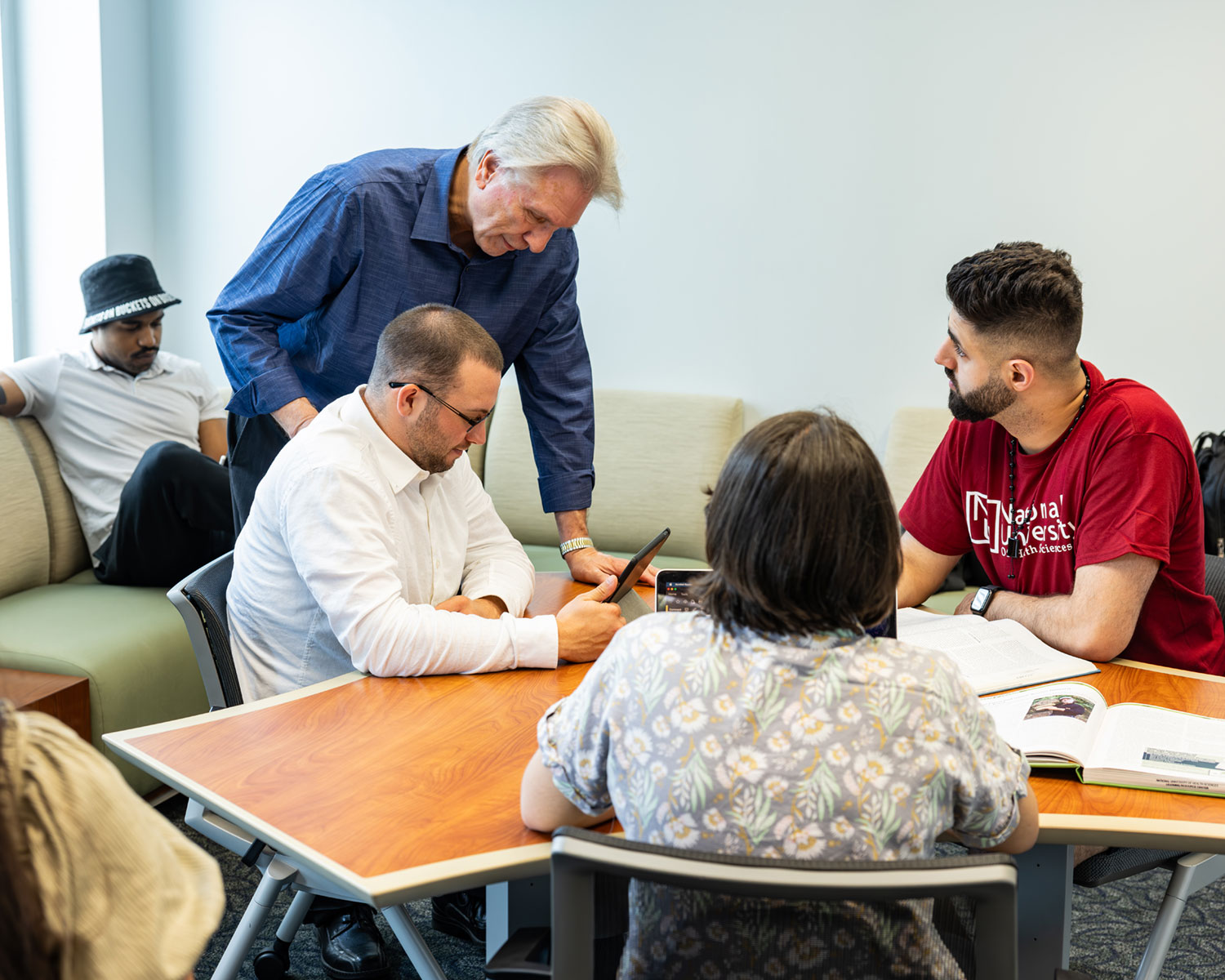 NUHS employee working with students