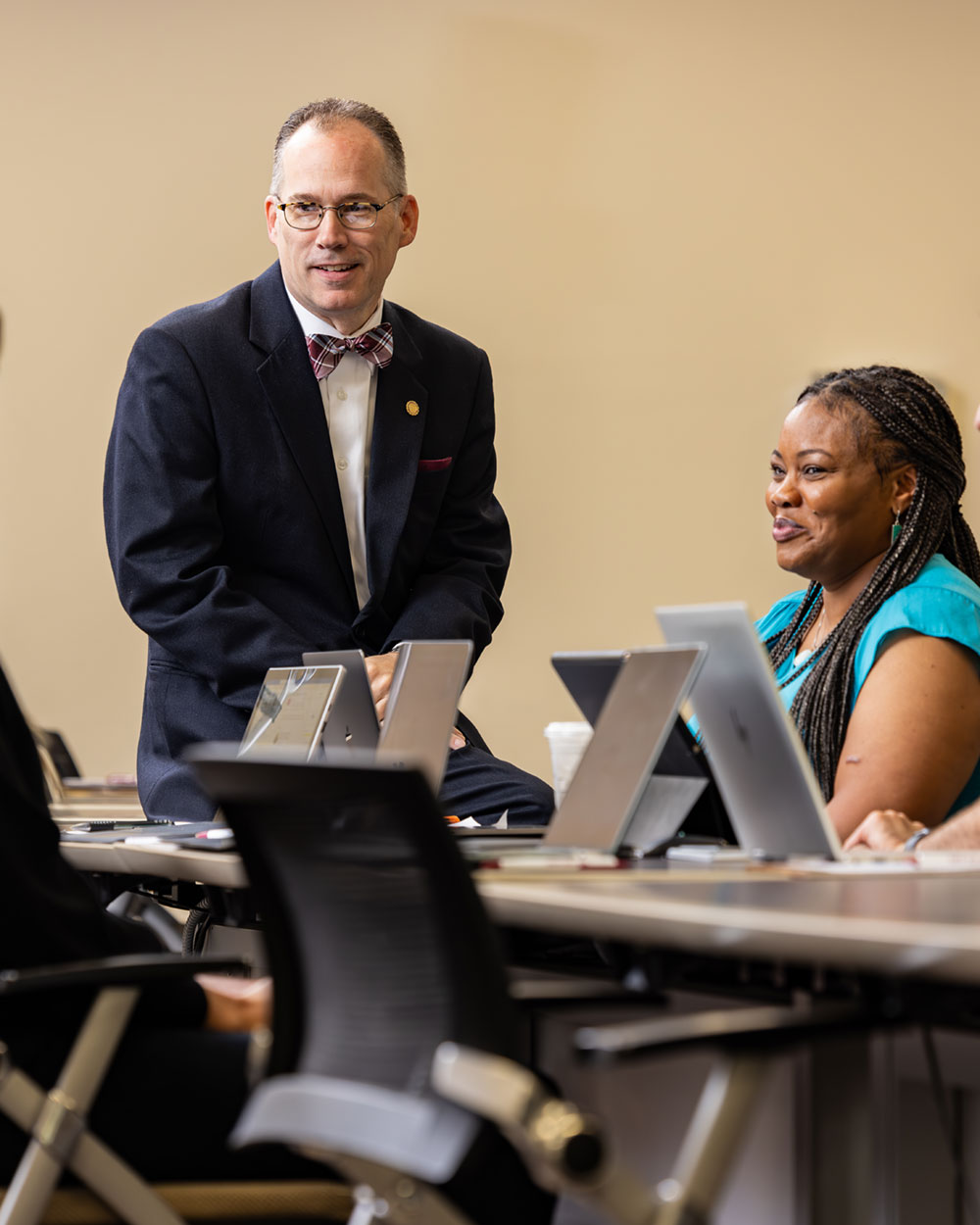 President Stiefel working with students in classroom